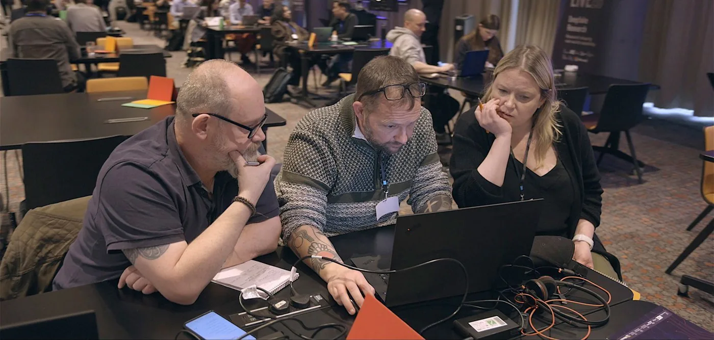 Participants working through a challenge together at the ACE Deepfake Detection hackathon